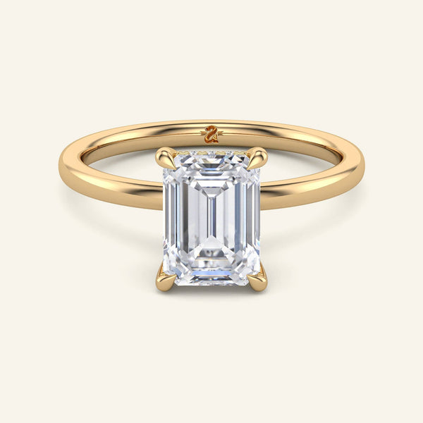 Emerald Cut Lab Diamond Ring in yellow gold with hidden halo solitaire setting, ideal for modern engagement styles.