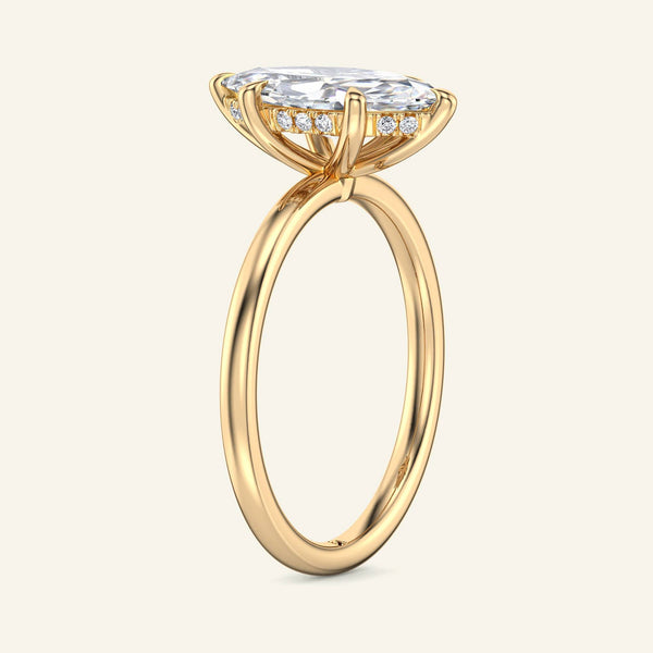 Side view of yellow gold Aura Marquise Hidden Halo Solitaire Diamond Ring showcasing hidden halo detail and slim band for elegant bridal wear.