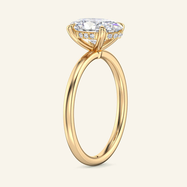Side view of 3 Carat Aura Oval Hidden Halo Lab Diamond Ring in yellow gold, showcasing the hidden halo beneath the raised solitaire diamond.