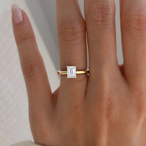 2 carat June Emerald Classic Solitaire Lab Grown Diamond Ring worn on hand, showcasing its elegant emerald-cut diamond and minimalist gold band.