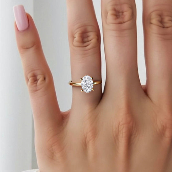 2 Carat June Oval Classic Solitaire Diamond Ring worn on hand, showcasing its elegant yellow gold band and sparkling oval cut lab grown diamond.