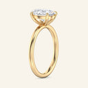 Side view of June Oval Classic Solitaire Diamond Ring in yellow gold, highlighting the raised four-prong setting and slim, smooth band design.