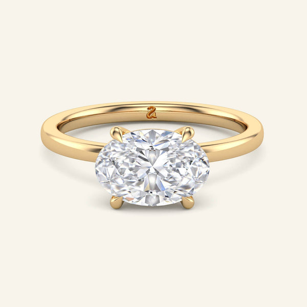 June Oval East-West Classic Solitaire Diamond Ring in yellow gold with a 2 carat lab-grown oval diamond set horizontally in a minimalist band.