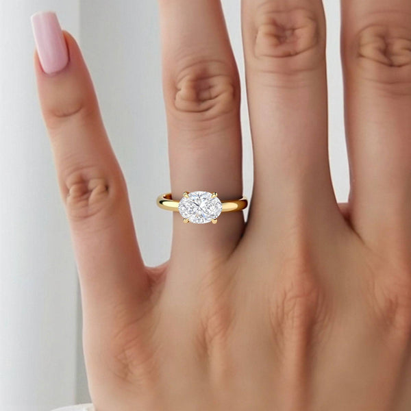 2 carat June Oval East-West Classic Solitaire Diamond Ring worn on hand, showcasing the horizontal oval diamond and sleek yellow gold band.