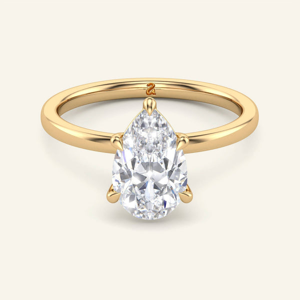 June Pear Lab Grown Diamond Solitaire Ring in yellow gold with a pear-shaped diamond in a classic prong setting for timeless elegance.