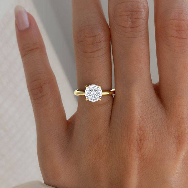 2 Carat June Round Classic Solitaire Diamond Ring worn on hand, showcasing its elegant yellow gold band and timeless round diamond cut.