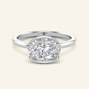 Mira Oval Half-Bezel Solitaire Diamond Ring in white gold with a 2 carat lab-grown oval diamond, set horizontally in a sleek half-bezel setting.