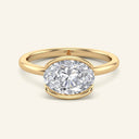 Mira Oval Half-Bezel Solitaire Diamond Ring in yellow gold with a 2 carat east-west set lab-grown oval diamond, showcasing a sleek modern bezel.