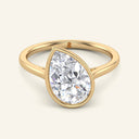 Remi Pear Bezel Solitaire Diamond Ring in yellow gold with a 2 carat tilted pear-shaped lab-grown diamond, bezel-set for a modern engagement look.