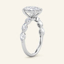 Profile view of Vera Oval Half-Coverage Solitaire Diamond Ring in white gold with raised oval center diamond and side marquise stones.
