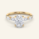 Vera Oval Half-Coverage Solitaire Diamond Ring in yellow gold with 2 carat lab-grown oval center diamond and marquise side stones on band.