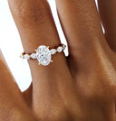 2 Carat Vera Oval Half-Coverage Solitaire Diamond Ring worn on hand, showcasing oval center stone and crescent-set marquise side diamonds.