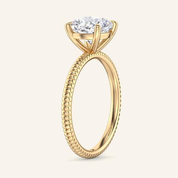 Side view of Bianca Cushion Ribbed Band Solitaire Diamond Ring in yellow gold showcasing elevated cushion cut diamond and textured ribbed band.
