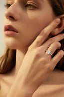 Model wearing Cora Oval Cathedral Pavé Solitaire Diamond Ring showcasing 2 carat oval cut diamond set in yellow gold with pavé detailing.