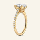 Side view of Cora Pear Cathedral Pavé Solitaire Diamond Ring | 2 Carat in yellow gold, highlighting cathedral arches and pavé diamond band.