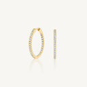 Kaia Medium lab grown diamond huggie hoops in 10K yellow gold with pavé-set stones. Elegant and affordable earrings for minimalist luxury style.