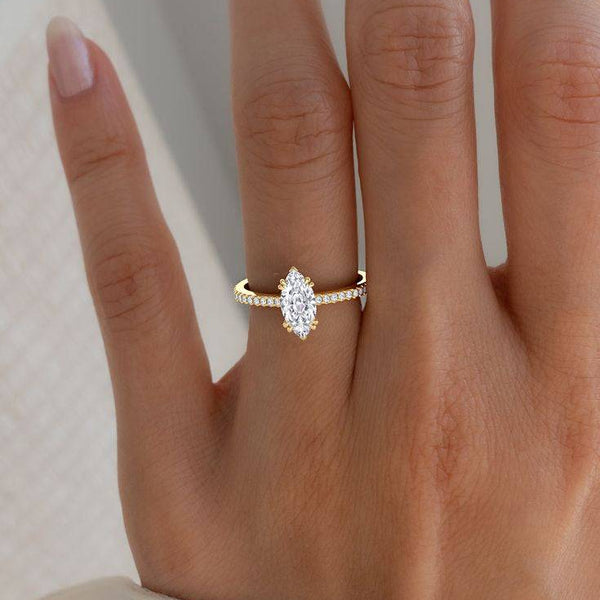 2 carat Cora Marquise Cathedral Pavé Solitaire Diamond Ring worn on hand, showcasing elegant marquise cut and pavé band in yellow gold setting.