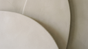 Soft putty plaster curves in clean daylight — abstract editorial backdrop for 9k vs 14k vs 18k gold