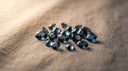 Loose London blue topaz gemstones, the December birthstone, on warm greige linen