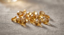 Loose honey-gold citrine gemstones, the November birthstone, on warm greige linen