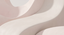 Soft blush and cream plaster curves in daylight — abstract editorial backdrop for pavé diamond charms