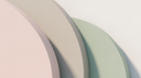 Blush, putty and sage arcs in soft daylight — abstract editorial backdrop for yellow vs white vs rose gold