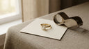 Yellow-gold lab-grown diamond ring on a card beside a jeweller's loupe in an atelier