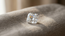 Radiant-cut lab-grown diamond concept — rectangular brilliant-faceted stone with cropped corners on warm greige linen in soft daylight