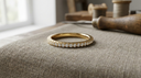 Full-circle solid yellow gold diamond eternity ring on warm greige linen, an unbroken row of lab-grown diamonds