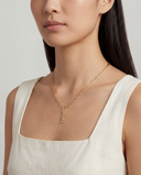 Model wearing Alya Stone Mama Script Charm Necklace in solid gold