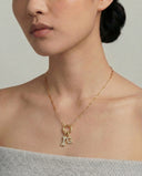 Model wearing Alya Stone Letter and Best Friend Bone pavé diamond necklace set in solid gold
