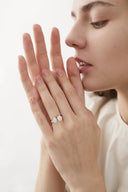 Model wearing Crest Round Pear Toi et Moi Lab Diamond Engagement Ring, showcasing 2 carat lab-grown diamonds in a unique dual-stone gold setting.