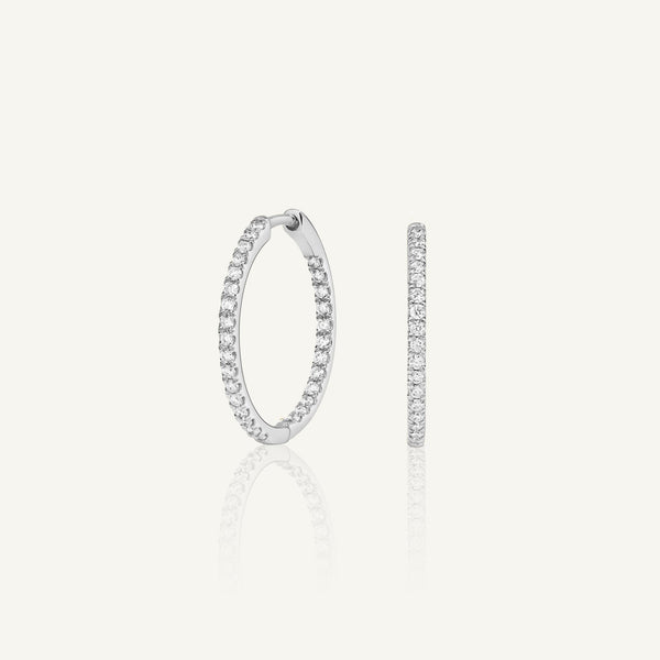 Kaia Medium lab grown diamond huggie earrings in 14K white gold featuring pavé diamonds. Sleek, modern hoops for everyday refined elegance.