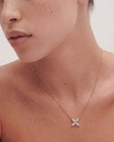 Model wearing Alya Stone Margot Marquise X necklace in solid gold